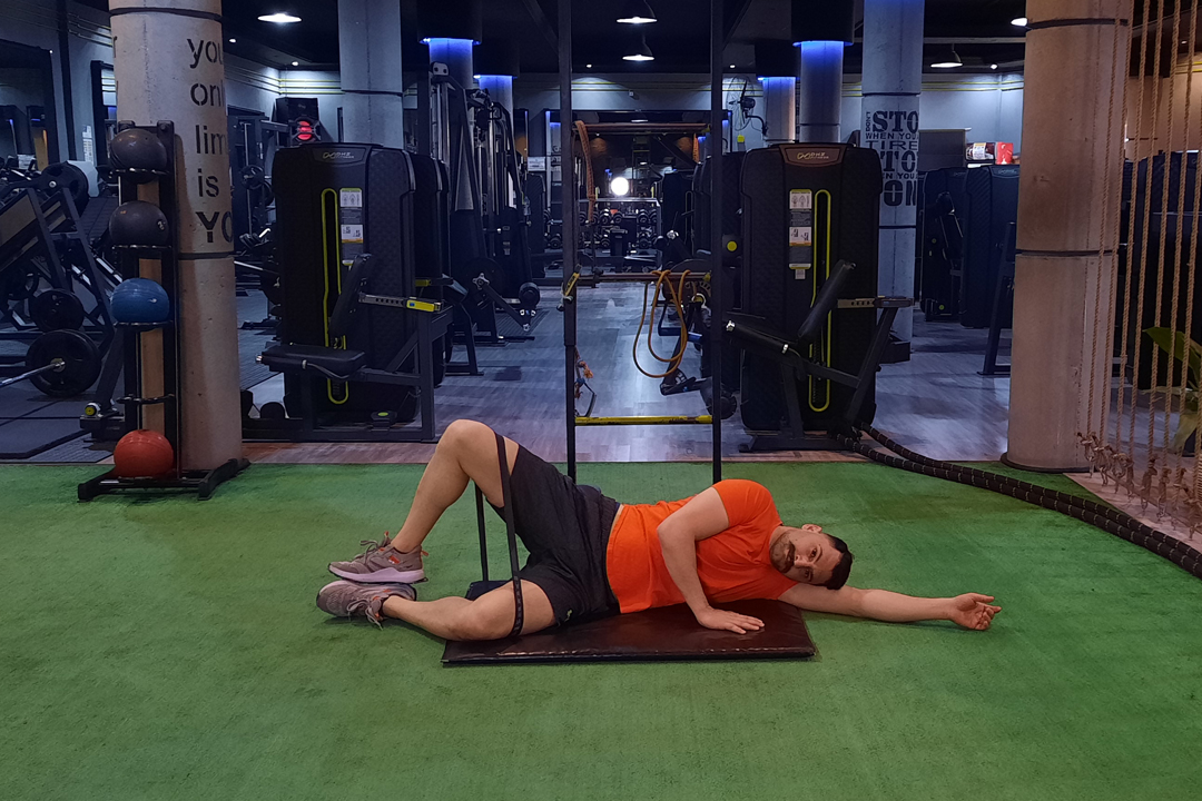 چرخش خارجی ران با کش زانو خم خوابیده