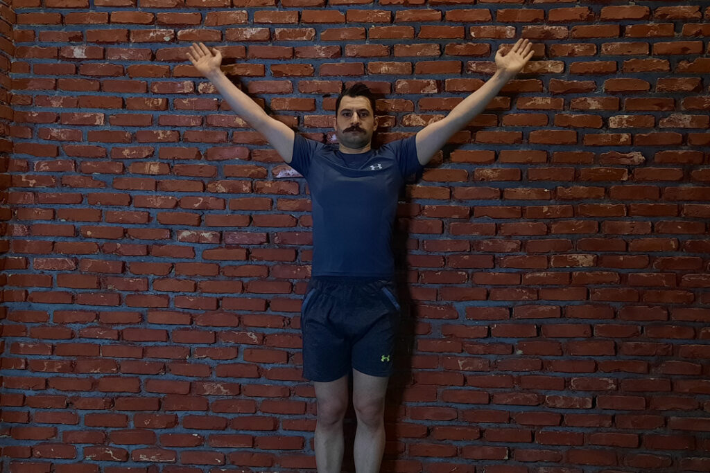 حرکت Y چسبیده به دیوار با حفظ راستای کتف با دمبل